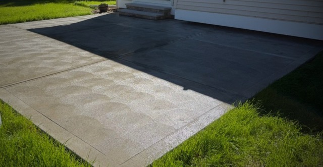 Gray patterned patio beside white house