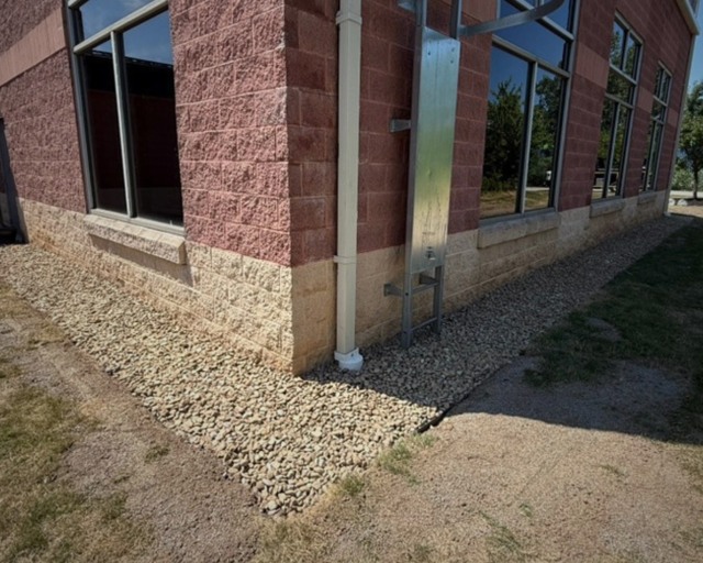Completed stone border at brick building corner