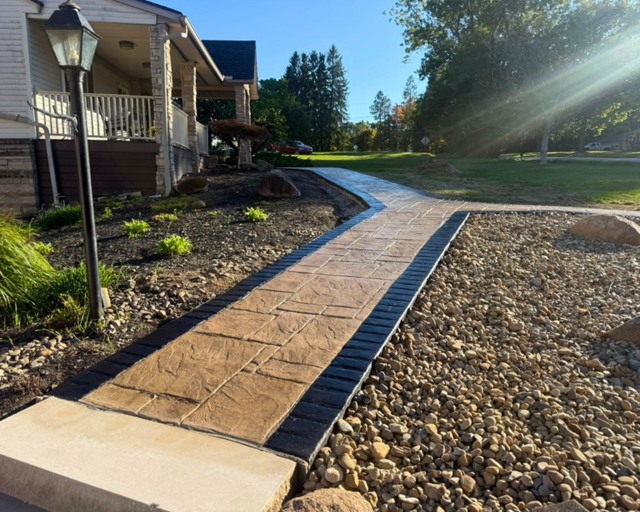 Wide completed stained walkway at house