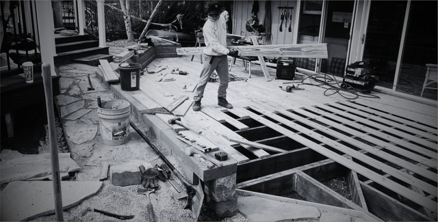 Worker building deck joists and stairs